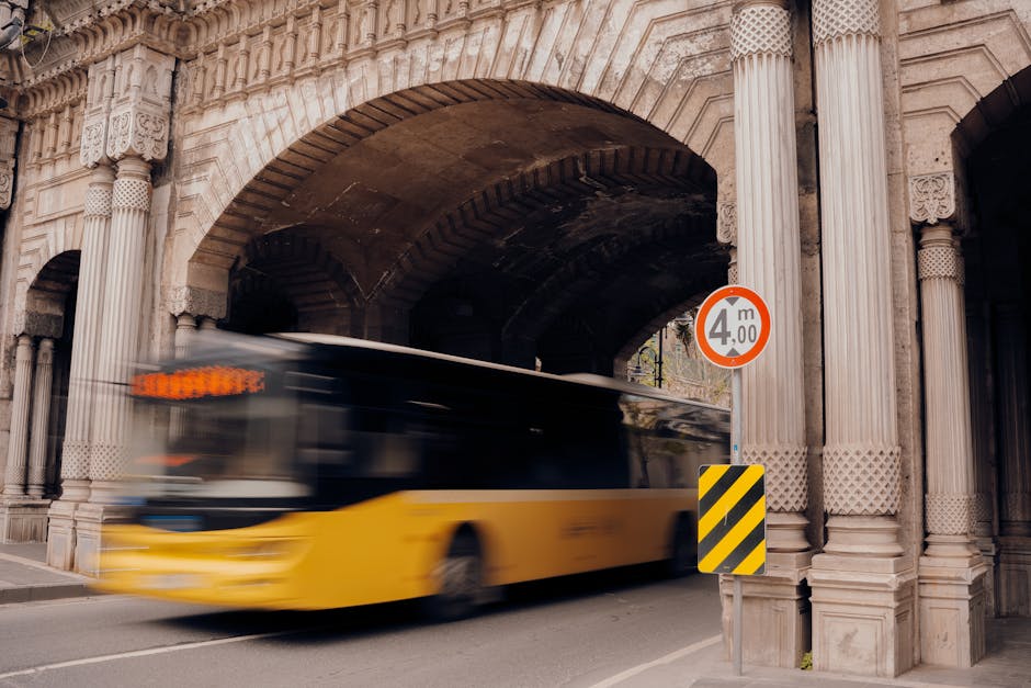 Yellow bus navigating height restrictions representing regulatory compliance