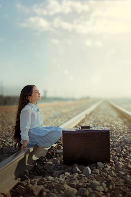 Girl sitting on tracks representing reflection on the financial journey